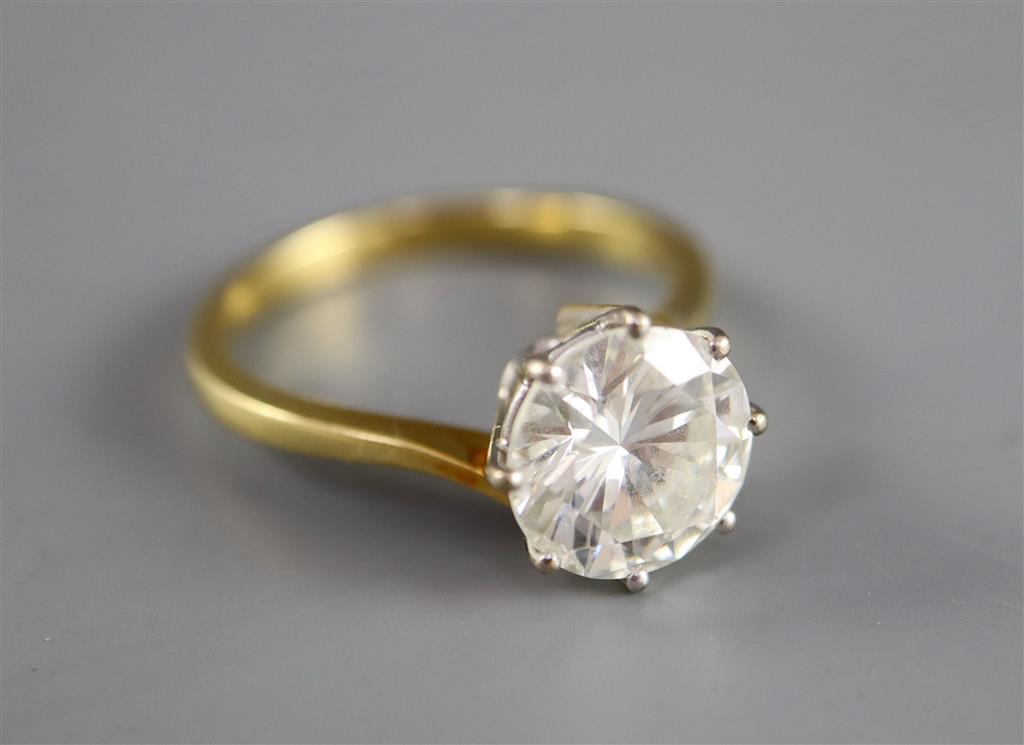 A modern 18ct gold and solitaire brilliant cut diamond ring,
